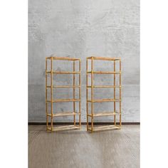 a pair of bamboo shelvings sitting next to each other on top of a wooden floor