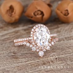 a close up of a diamond ring on a wooden surface