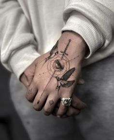 a person's hand with a tattoo on it and an arrow in the middle