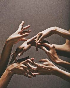 many hands reaching for each other in the air