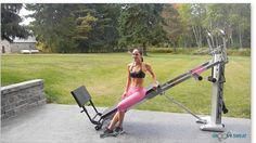 a woman standing next to a pink gym equipment