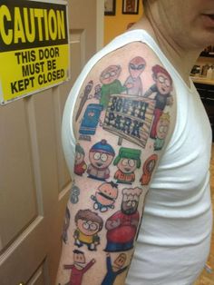 a man's arm with cartoon characters on it and caution sign in the background