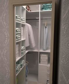 an open closet with towels and other items in it