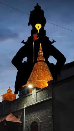 the silhouette of a man on top of a building