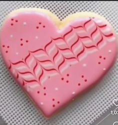 a heart shaped cookie sitting on top of a table