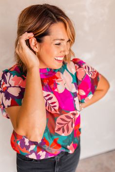 The Sittin' Pretty Floral Blouse by THML is so stunning you'll be 'sittin' pretty' for any occasion! Liven up your look with a few pops of color, then tuck in the blouse for a more shapely fit. Whether you're pairing it with some denim or work slacks, you'll be the best dressed in the room! Ashley is 5'4" and is wearing a size small Fit: Relaxed Lightweight Floral Blouse Color: Orange, teal, burgundy, pink Material: 100% Polyester Styled With: Carlene Denim Care Instructions: Hand Wash Separately in Cold Water, Do not bleach, Lay flat to dry Teal Burgundy, Work Slacks, Nickel And Suede, Concert Looks, Denim Joggers, Midi Dress Party, Summer Chic, Summer Wedding Dress, Wedding Guest Dress Summer