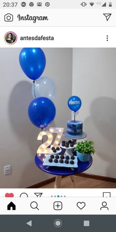 a blue cake and balloons on a table with an instagram sign above the cake