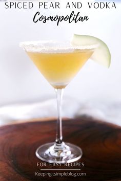 a cocktail in a martini glass with an apple slice on the rim