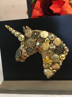 a unicorn brooch sitting on top of a black box