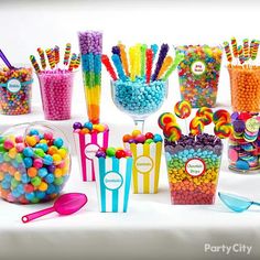 a table topped with lots of candy and lollipops