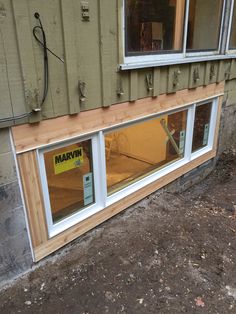 the side of a house that is being built with windows and sidings on it