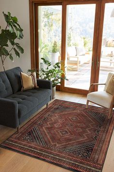 a living room filled with furniture and a large rug