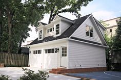 a white house with black roof and windows