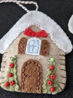 a felt ornament with a house on it