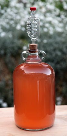 a glass bottle sitting on top of a wooden table