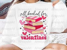 a woman sitting on top of a bed wearing a shirt that says, all books are valentine's