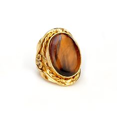 A large, high quality, mesmerizing tiger's eye oval cabochon, in brass bezel, on an ornate brass band.  tiger's eye size : 26 x 19 x 8 mm brass base/band base: 34 x 22 mm ring width: 34 mm The open ring band is pliable for adjustment to most finger sizes.  Questions: please send me a message. Ornate Gold Cabochon Rings, Ornate Gold Rings With Cabochon, Victorian Oval Brown Jewelry, Brown Oval Victorian Jewelry, Victorian Style Oval Brown Jewelry, Victorian Brown Oval Jewelry, Big Tiger, Eye Rings, Brass Band