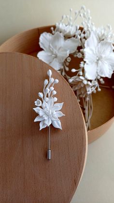 a wooden table topped with white flowers on top of it