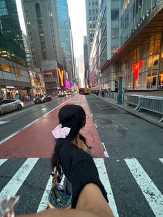 a woman is taking a photo on the street