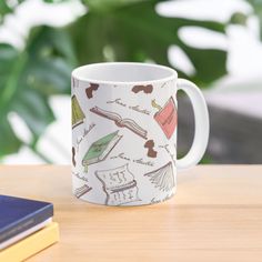 a white coffee mug with books on it