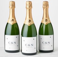 three bottles of champagne on a marble surface