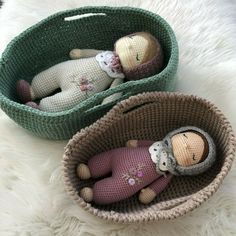 two knitted dolls in baskets on a white furnishing