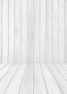 an empty white room with wood flooring and vertical lines on the wall behind it