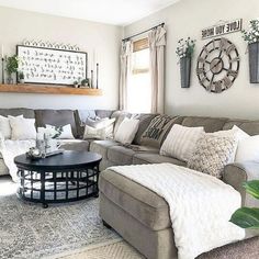 a living room filled with furniture and lots of pillows on top of it's couches