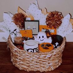 a basket filled with halloween items on top of a wooden table