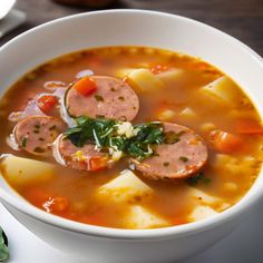 a white bowl filled with meat and vegetable soup