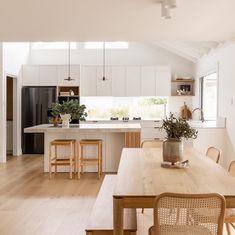 an open kitchen and dining room with white walls