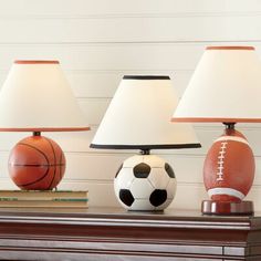 three lamps with different sports balls on them