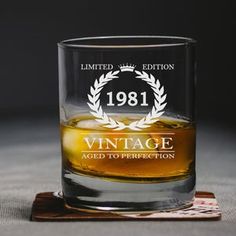 an old fashioned whiskey glass sitting on top of a coaster