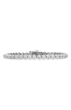 A total of 61 round diamonds dazzle on this handcrafted tennis bracelet set in icy 18-karat gold. 7" inner circumference Hinge with box-clasp closure Total diamond weight: 4.59ct. Color: G Clarity: VS 18k gold/diamond Imported >Diamond Guide Dazzling Platinum Tennis Bracelet With Prong Setting, Diamond White Brilliant Cut Tennis Bracelet, Fine Jewelry Tennis Bracelet With Brilliant Cut, Lab Grown Diamond Bracelet With Prong Setting, Diamond Tennis Bracelet With Brilliant Round Cut, Dazzling Tennis Bracelet With Prong Setting, Diamond Tennis Bracelet With Brilliant Cut, Diamond White Tennis Bracelet With Diamond Cut, Platinum Diamond Bracelet With Round Cut Accents