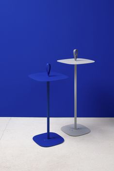 two blue tables with one standing on the other