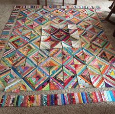 a multicolored patchwork rug on the floor