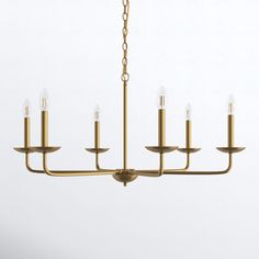 a brass chandelier with five candles hanging from it