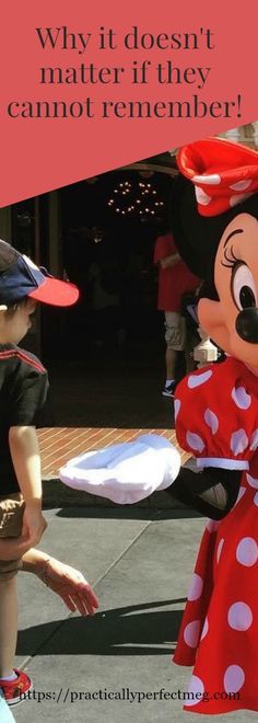 a woman in a minnie mouse costume talking to a child