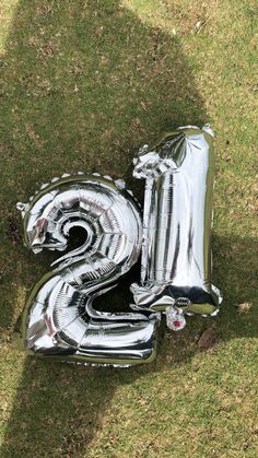 the number three balloon is laying in the grass