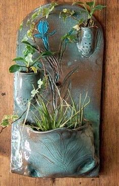 a blue bird is sitting on top of a planter