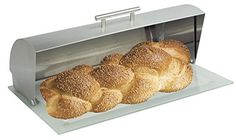 three loaves of bread sitting in front of a toaster on a white background