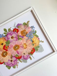 an image of a bouquet of flowers in a white frame