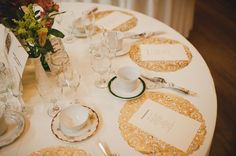 the table is set with place cards and silverware