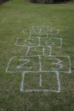 a yard with chalk drawings on the grass