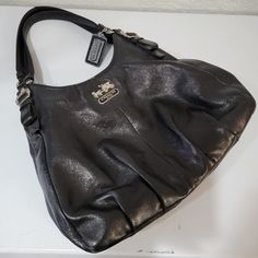 Coach Madison Pearlized Black Leather Maggie Hobo Shoulder Bag Purse Tote In Great Condition With Some Wear Around One Of The Interior Pockets. Seen In Photos. Elegant Formal Hobo Bag With Gunmetal Hardware, Designer Black Hobo Bag For The Office, Black Hobo Bag With Branded Hardware And Top Handle, Elegant Hobo Satchel With Gunmetal Hardware, Black Hobo Bag With Double Handle And Branded Hardware, Black Double Handle Hobo Bag With Branded Hardware, Coach Leather Hobo Bag With Branded Hardware, Black Hobo Bag With Branded Hardware For Travel, Classic Black Hobo Bag With Gunmetal Hardware