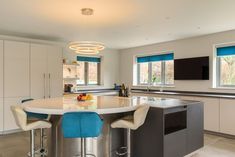 a kitchen with two stools and a center island