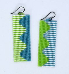 pair of earrings with green and blue beads on white background for use in jewelry design