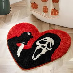 a heart shaped rug with a black and white cat on it