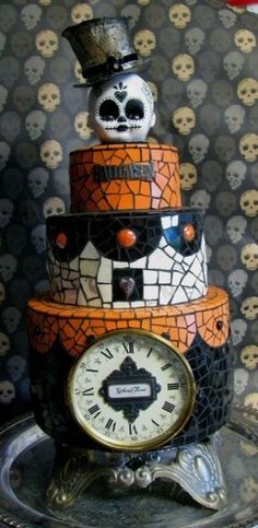 there is a cake with skulls on it and a clock