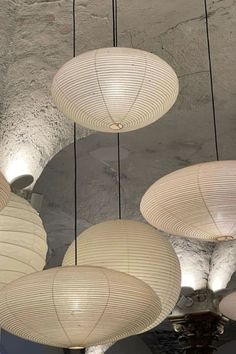 several white lanterns hanging from the ceiling